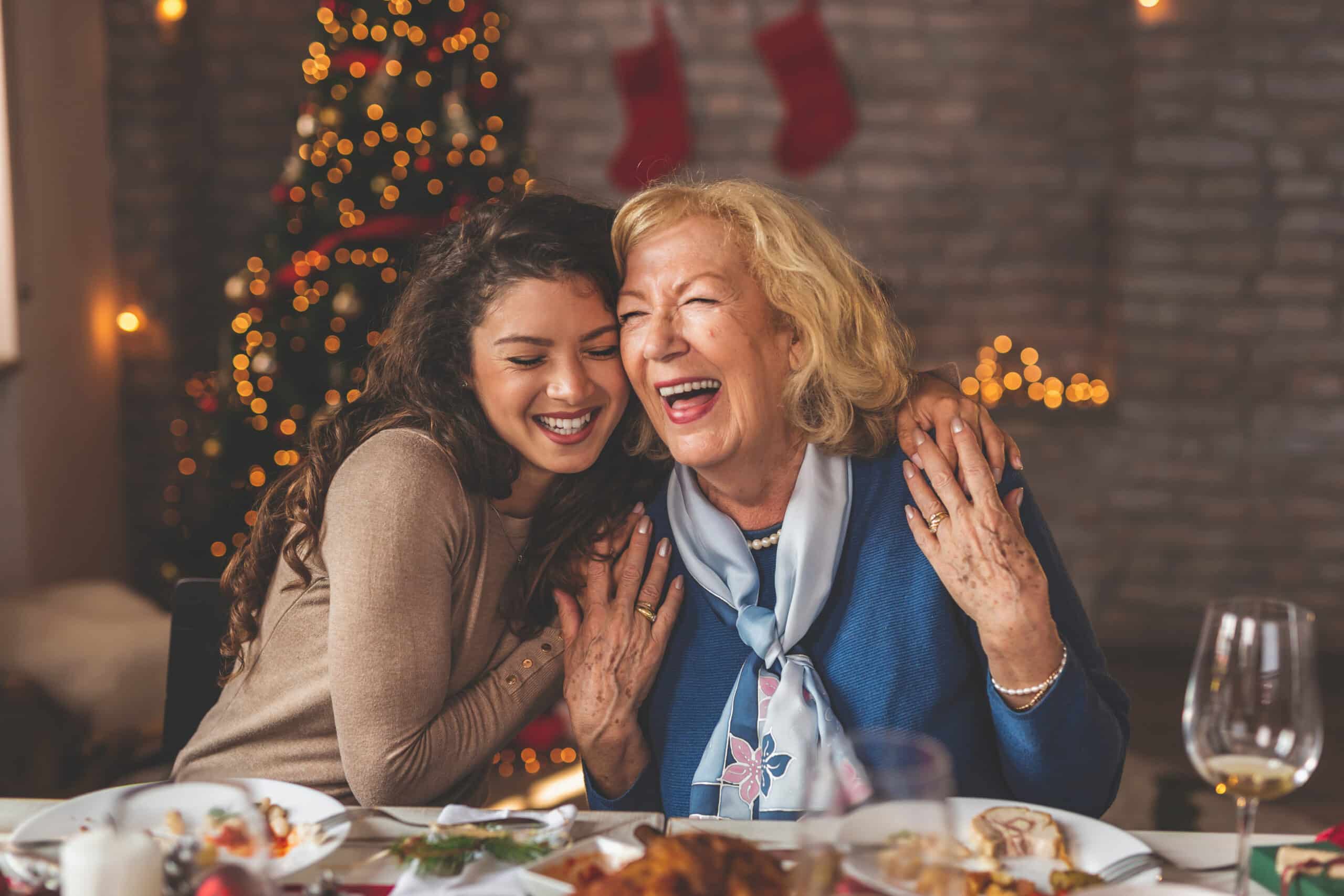 Mother and daughter hugging over Christmas dinner What gastroparesis is and why it makes holiday meals so challenging