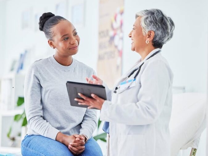 Doctor, women and tablet for happy healthcare, hospital news and support with test results or exam on bed. Senior nurse and patient with digital registration, clinic sign up and medical consultation How GEBT expands access to gastroparesis testing